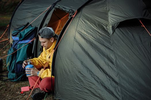 一名露营者在森林露营地的帐篷外安装了煤气燃烧器