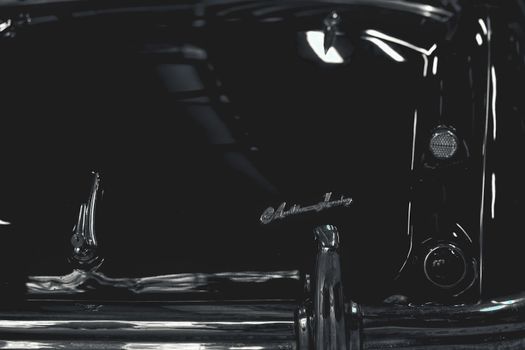 Close-up of a vintage car's rear in black and white showcasing classic design details.