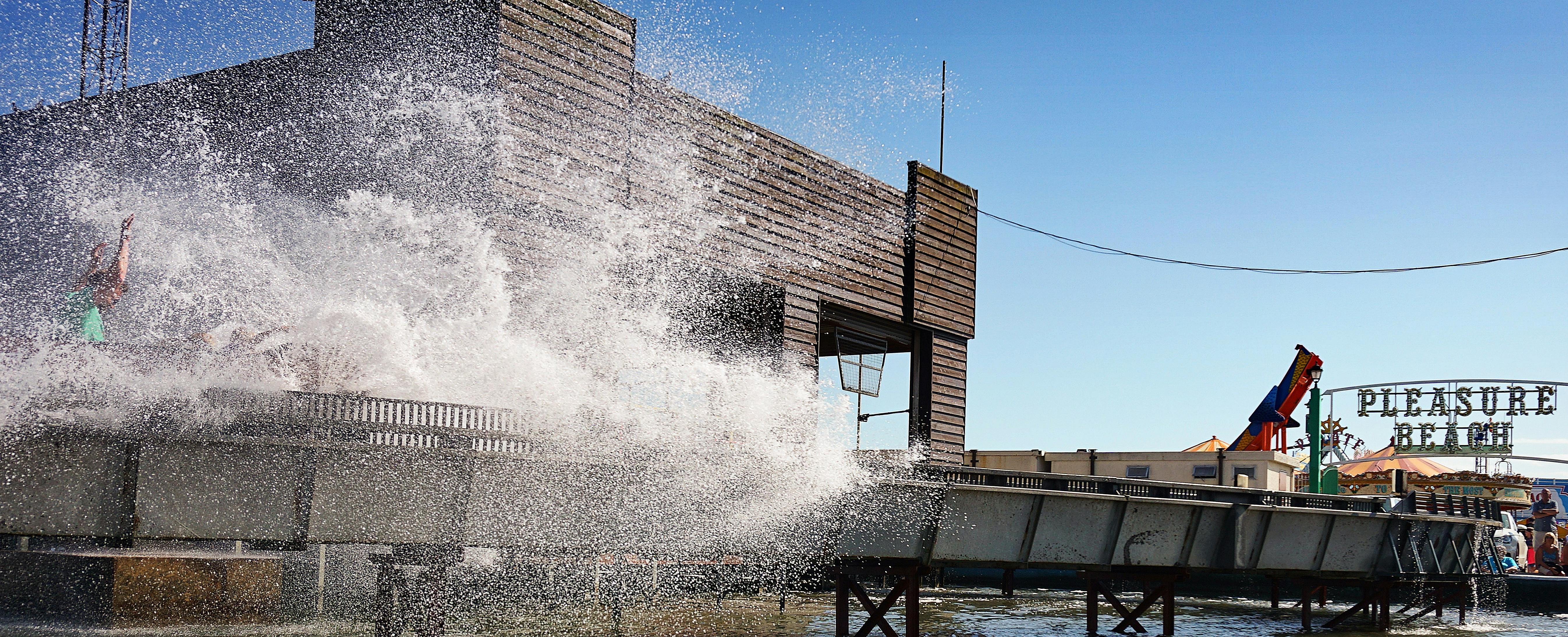 Dynamic splash against a vibrant blue sky at Great Yarmouth's Pleasure Beach.