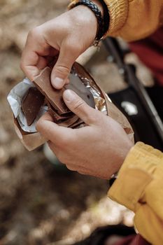 一个人在户外露营旅行中，打碎牛奶巧克力，享受休闲时光