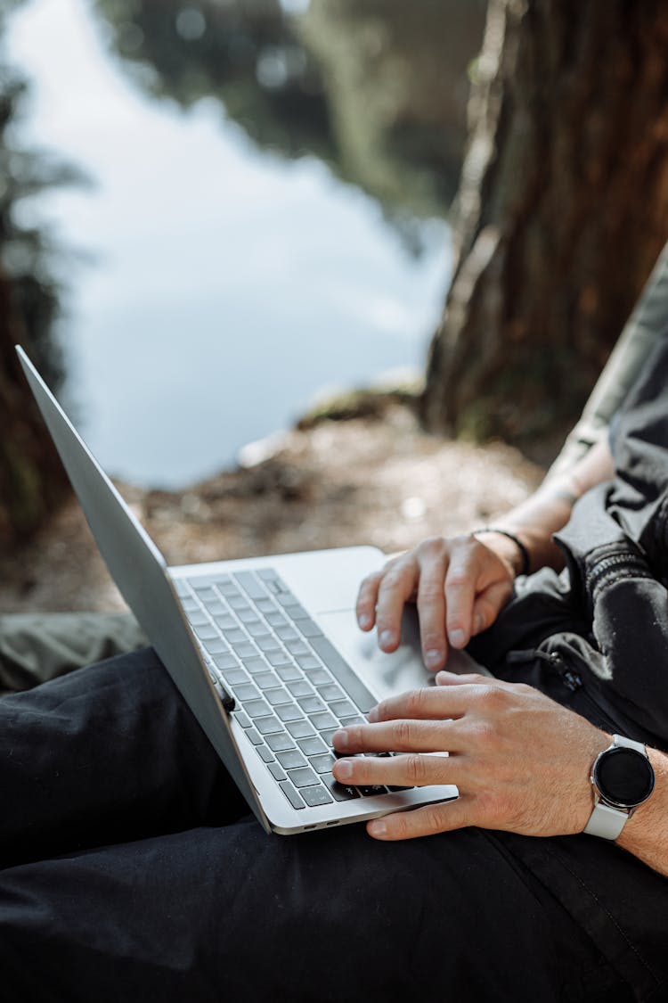 Person In Black Jacket Using Laptop Computer