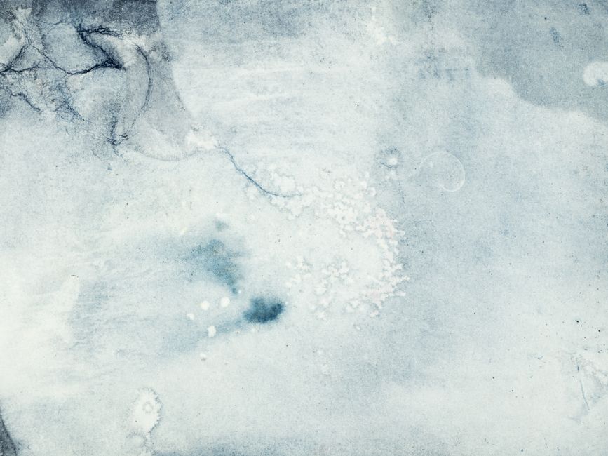 Close-up of a textured icy surface with cool winter hues, ideal for backgrounds and designs.
