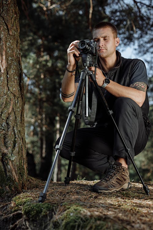 Man in Black T-shirt Holding a Camera