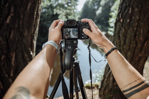 Person Holding Black Dslr Camera