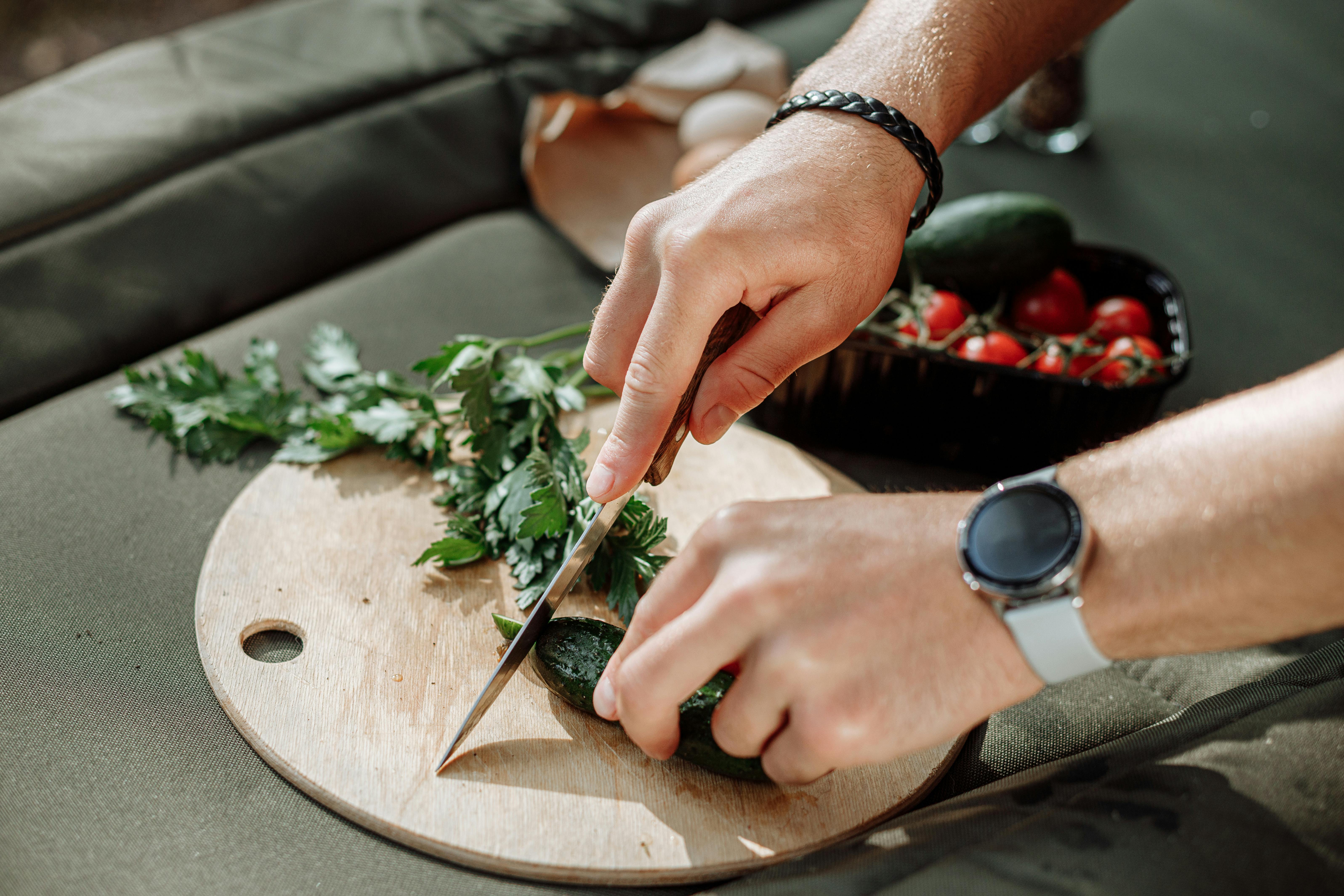 Close-Up Shot of a Knife and Sliced Vegetables on a Wooden Chopping Board ·  Free Stock Photo