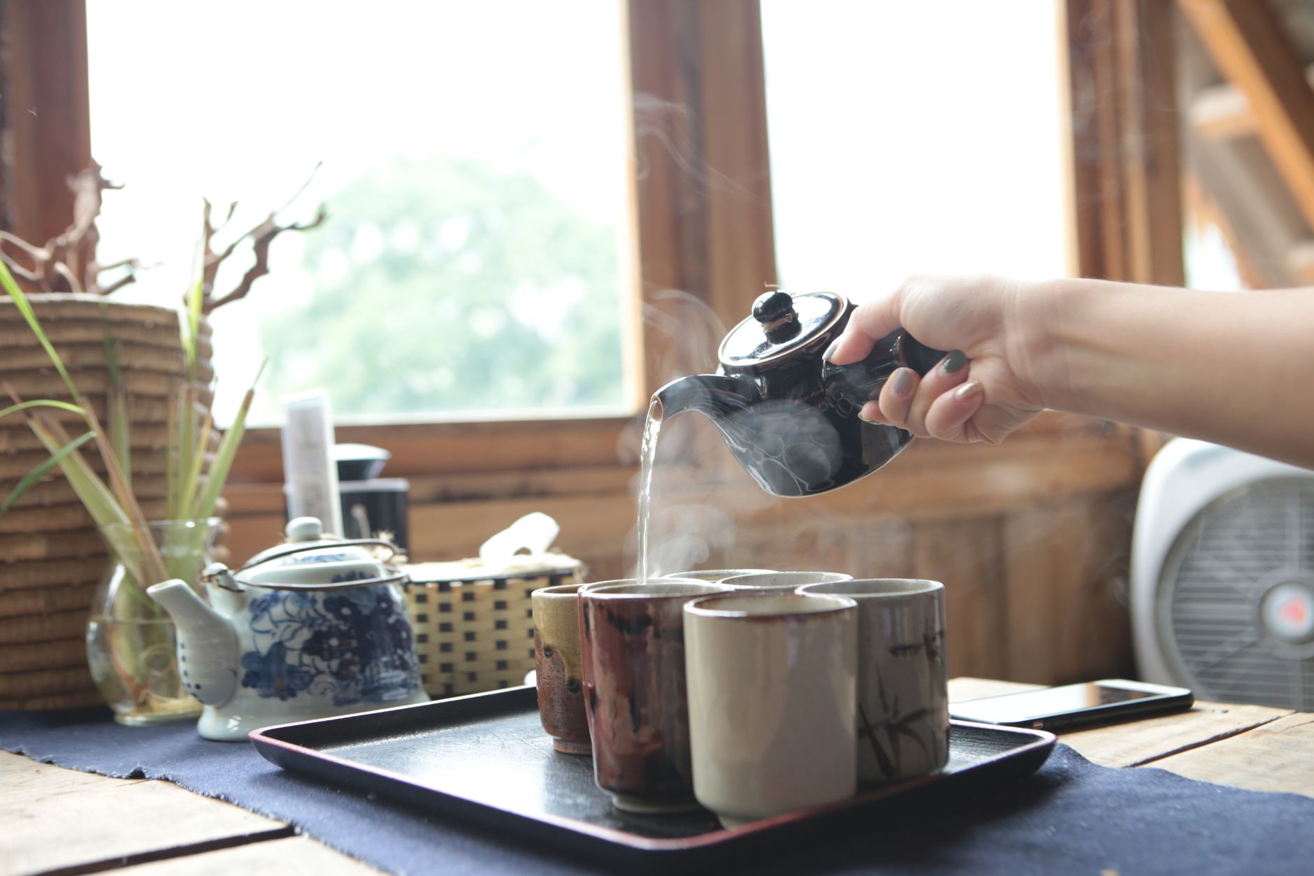 Steaming mug of ginger tea with honey and lemon slices on a tray Steaming mug of ginger tea with honey and lemon slices on a tray