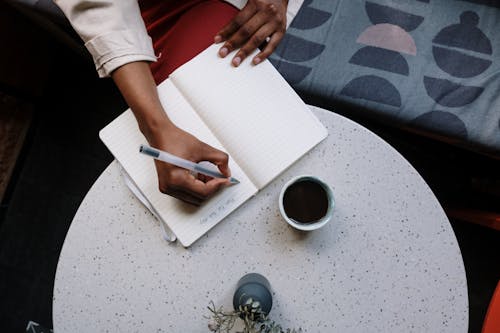 Person Holding White Pen and White Paper