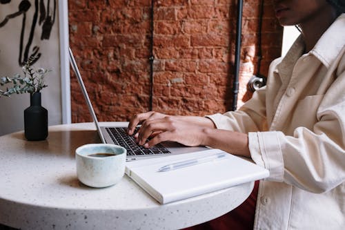 Free Person in White Long Sleeve Shirt Using Macbook Pro Stock Photo