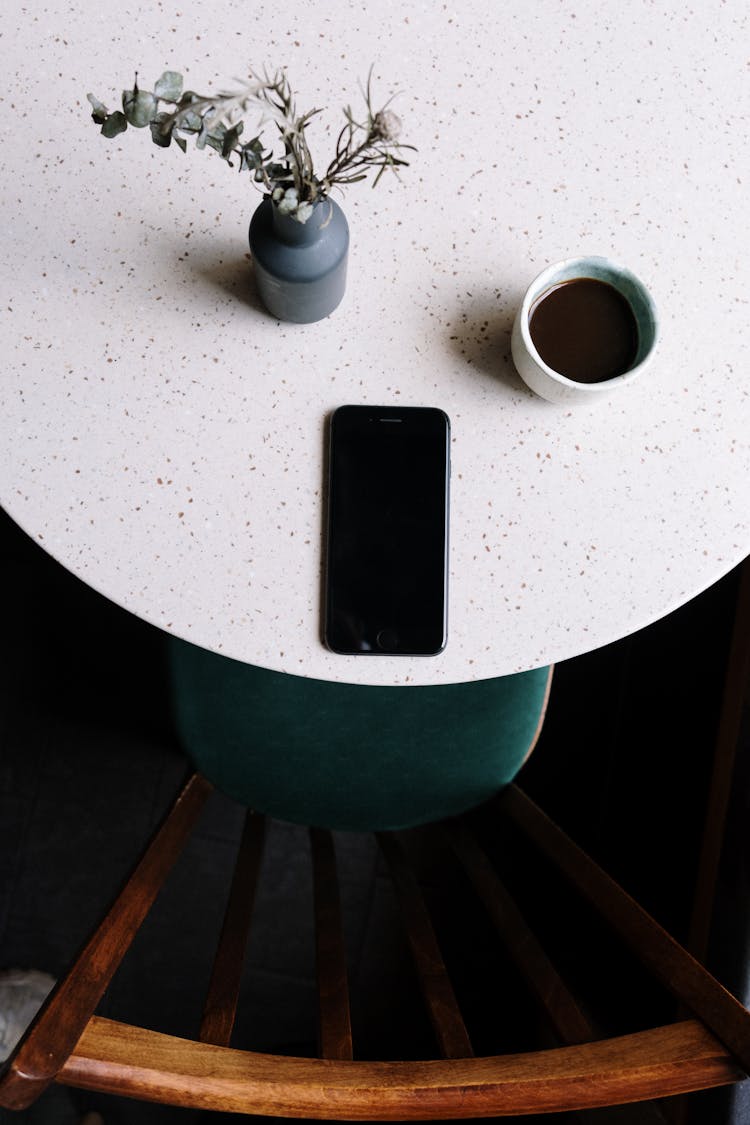 Black Iphone 5 On White Round Table