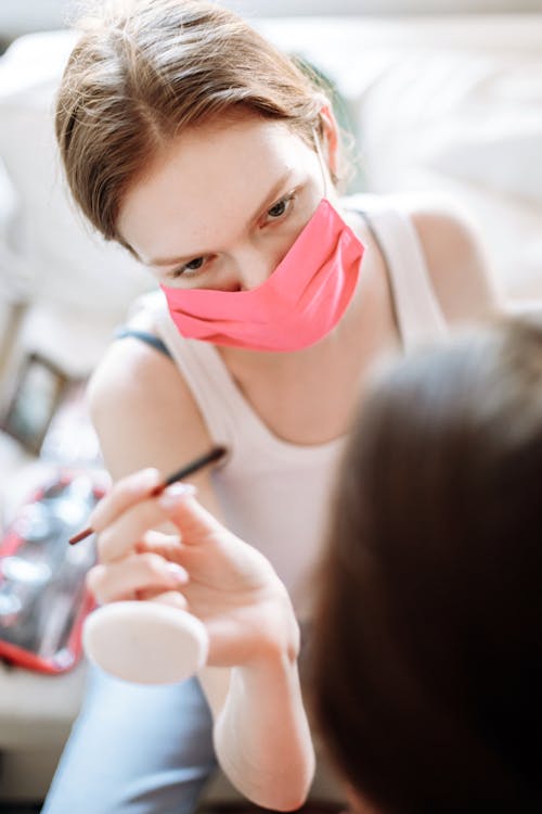 A Female Makeup Artist Wearing a Facemask