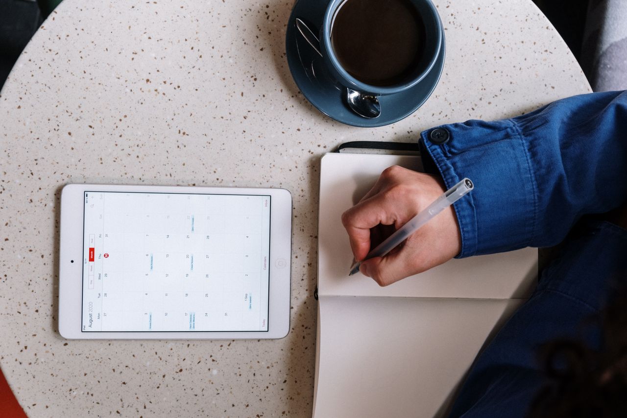 Aesthetic Digital Planner | Daily, Weekly & Monthly Planner Overhead view of planning with a tablet, notebook, and coffee on a table