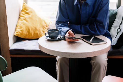 Man in Blue Suit Jacket Sitting by the Table