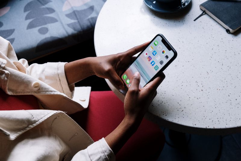 Person scrolling through a social media feed to research content