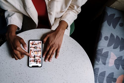 Free Person in White Long Sleeve Shirt Holding Silver Iphone 6 Stock Photo