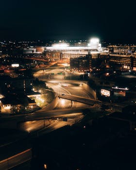 A vibrant view of Minneapolis at night, featuring illuminated roads and city lights.
