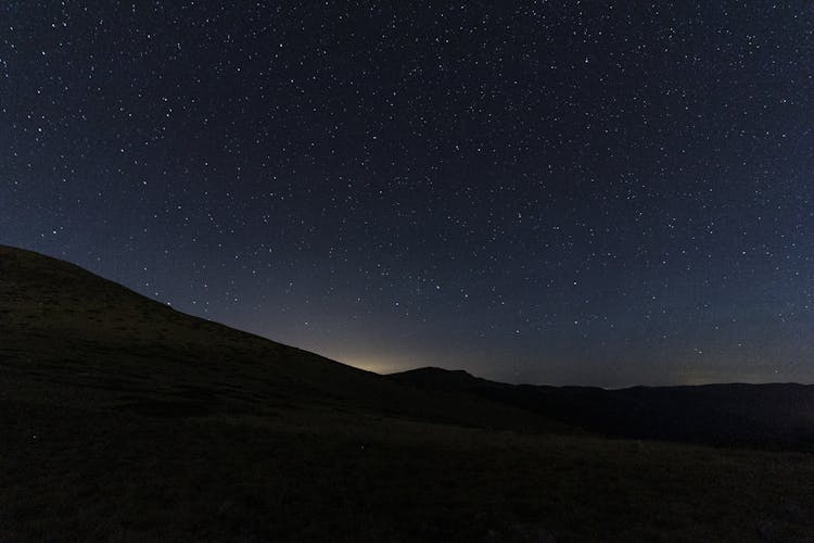 Silhouette Of Mountain And Valley At Night