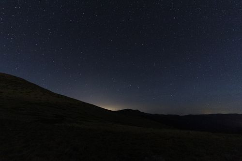 Free Explore the breathtaking view of a starry night sky over the mountains in Madrid, Spain. Stock Photo