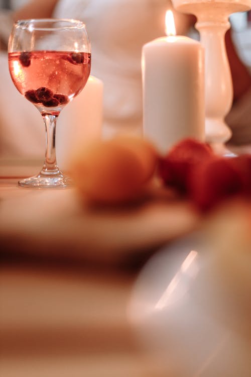 Free A Clear Wine Glass Near the Burning Candle Stock Photo