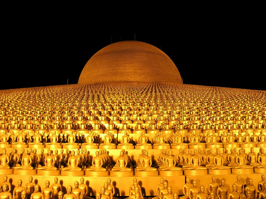 A stunning view of golden Buddha statues adorning the iconic Dhammakaya Pagoda in Thailand.