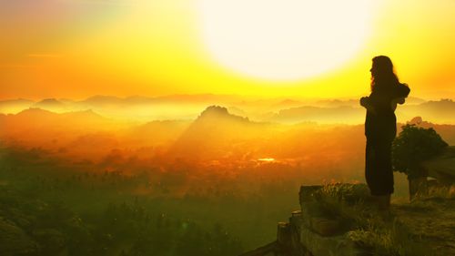 Free A mesmerizing silhouette view over Hampi's landscape at sunrise, capturing the essence of serenity. Stock Photo