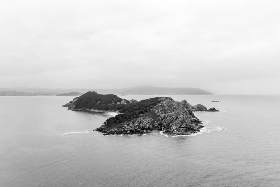 Aerial shot of the Cíes Islands in Galicia, Spain. Monochrome sea and rocky landscape create a moody seascape.