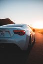 Stylish cope car on road in sunset light
