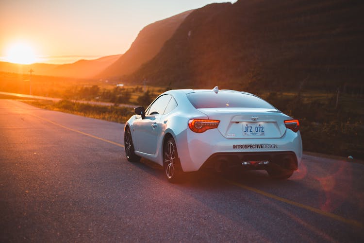 Stylish Grand Tourer Car On Sunny Highway