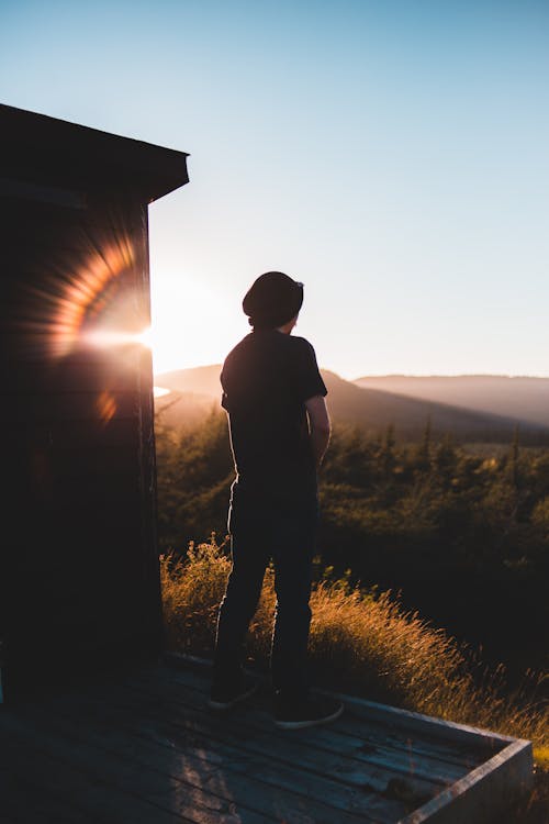 Unrecognizable man standing above mountain terrain