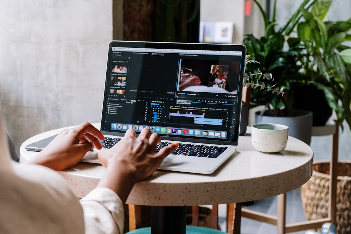 Free Person Using Macbook Pro on White Table Stock Photo