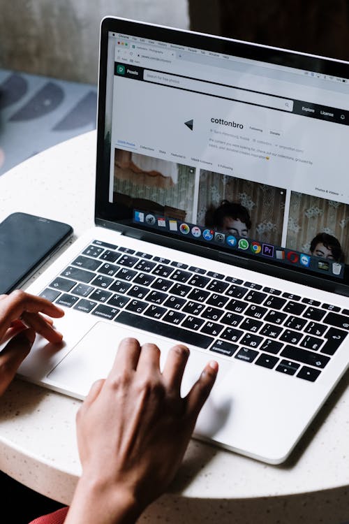 Person Using Macbook Pro on Table