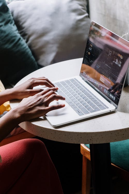 Person Using Macbook Pro on Table