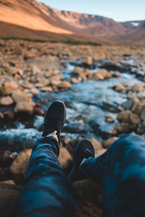 Crop tourist sitting near creek