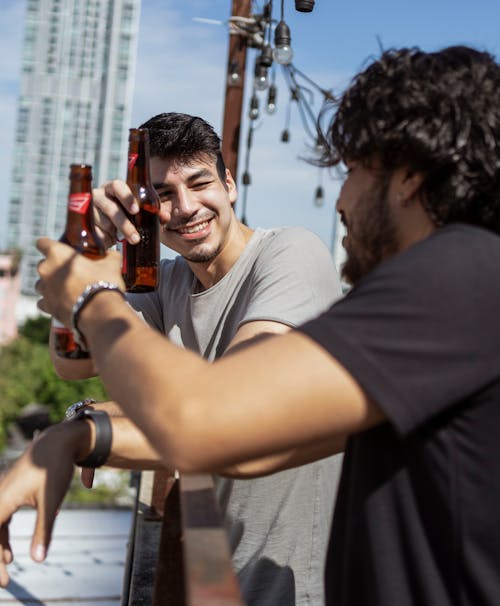 Free Men Toasting Drinks while Having Conversation Stock Photo
