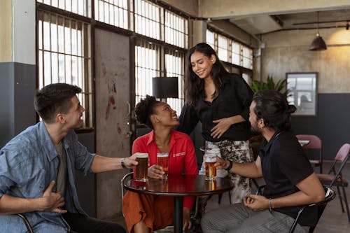 Free Happy People with Beers in Restaurant Stock Photo