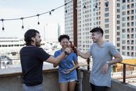Man in Black Crew Neck T-shirt Holding Brown Wooden Stick Beside Woman in Blue Sleeveless