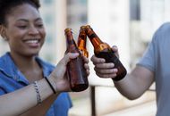 Woman Holding Brown Glass Bottle