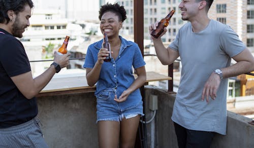 Free A Group of Friends Having Fun while Holding Beer Bottles Stock Photo