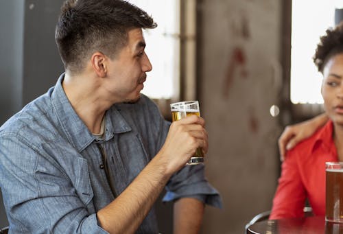 Man Drinking Beer with Friends