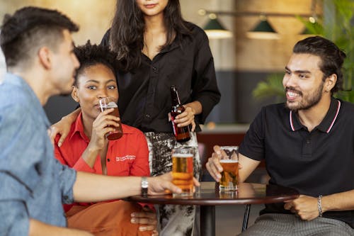 Friends Sitting at Table Drinking Beer