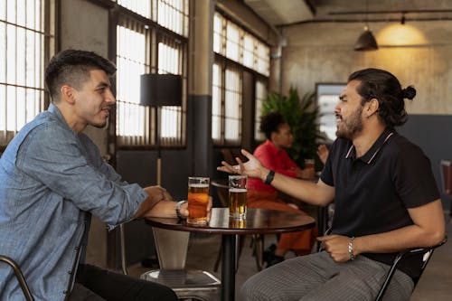 Men Having Conversation while Looking at Each Other