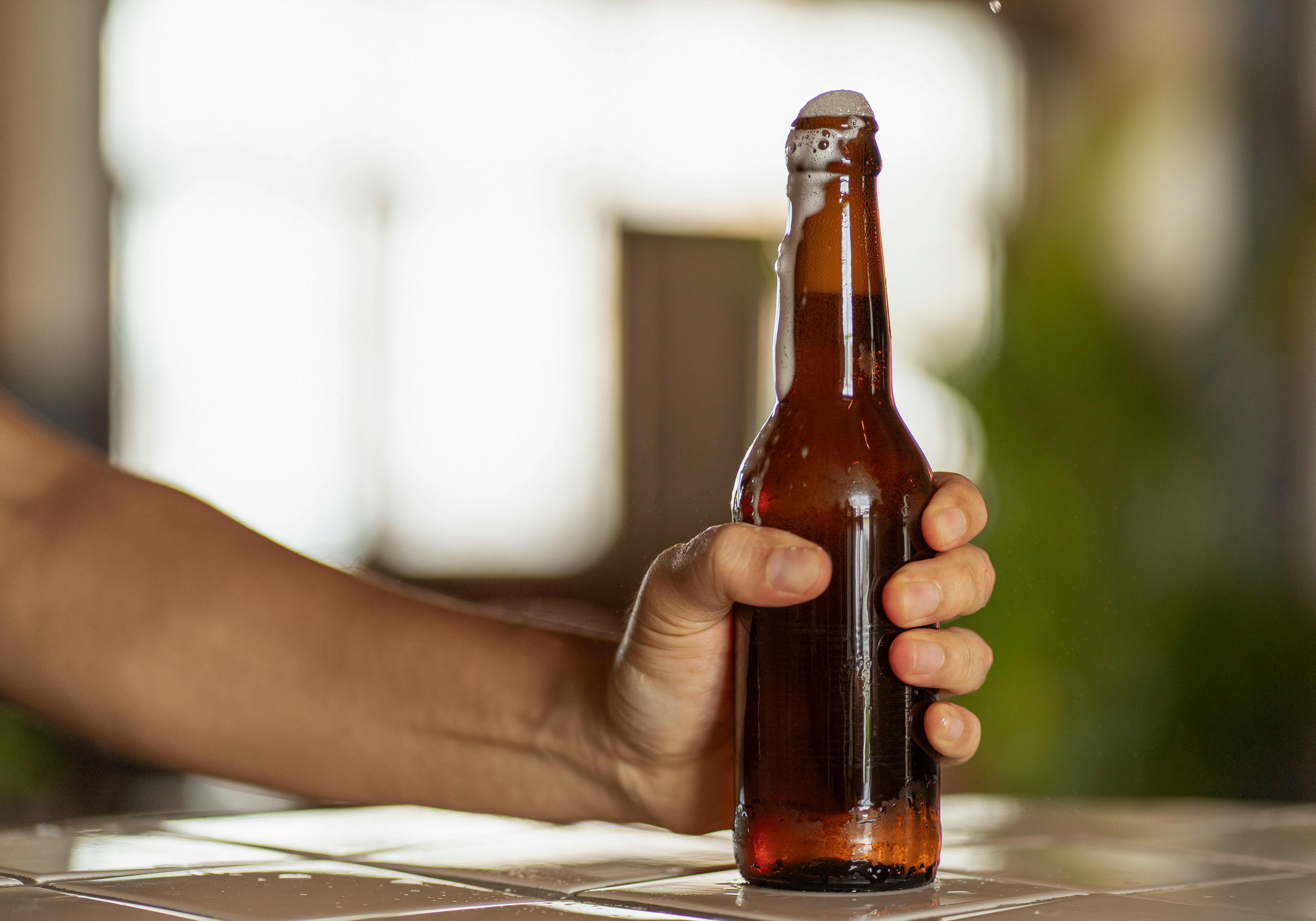 Beer Bottle in Hand · Free Stock Photo