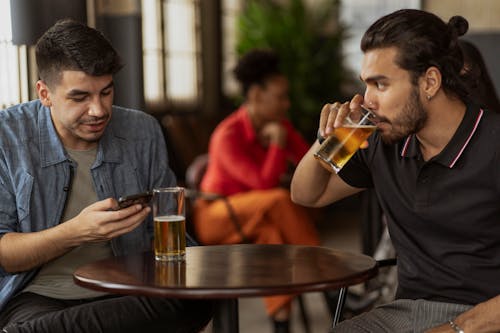 Two Men Having Beer in Bar 