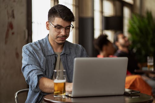 Man Using Laptop in Canteen