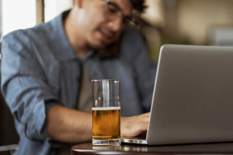 Man With Beer By Laptop