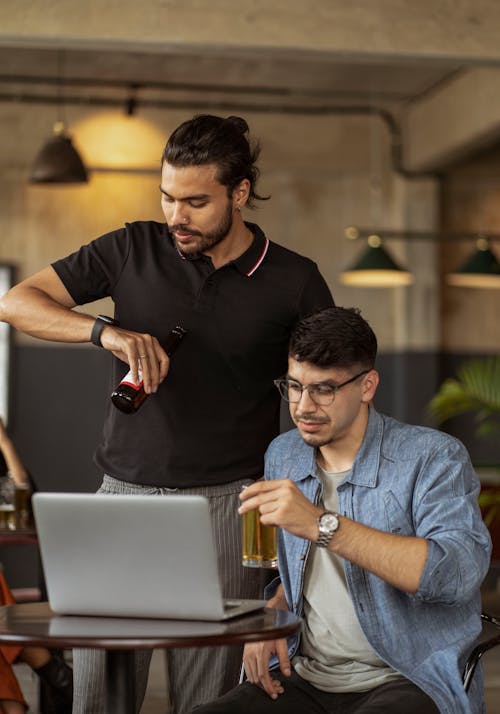 Men Sitting in Cafe Working on Laptop