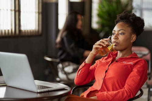 Woman Drinking Beer while Working