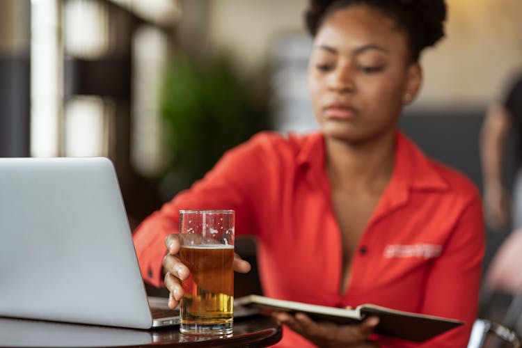 Woman Reaching For A Glass Of Beer 