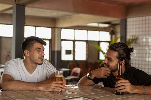 Two Men Talking and Having Beer