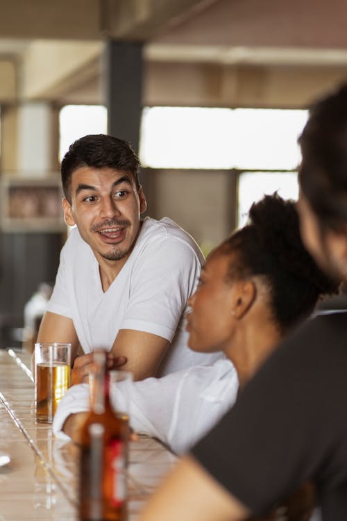 Man and Woman Sitting at Bar Counter