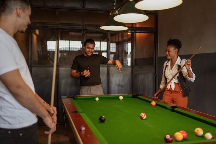 People Playing Billiard And Drinking Beer 